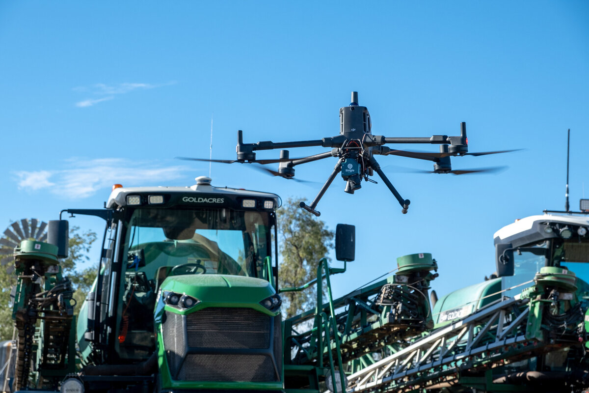 A drone flies over a spray rig